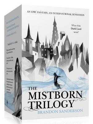 A boxed set of the "Mistborn Trilogy" by Brandon Sanderson, featuring a minimalist design with black and white illustrations of towers and a figure, with blue accents and text.