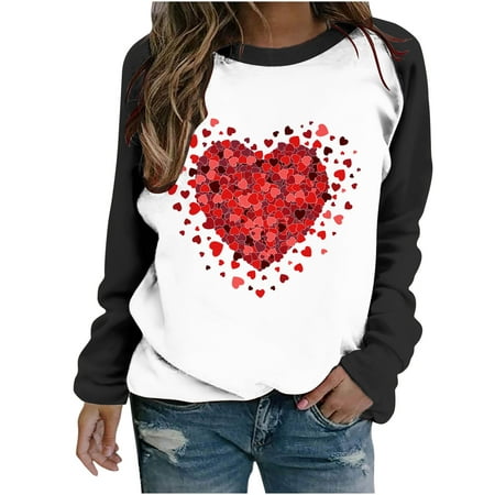Long sleeve casual top featuring a white body with a large red heart made of smaller hearts, black sleeves, and a relaxed fit, perfect for Valentine's Day.