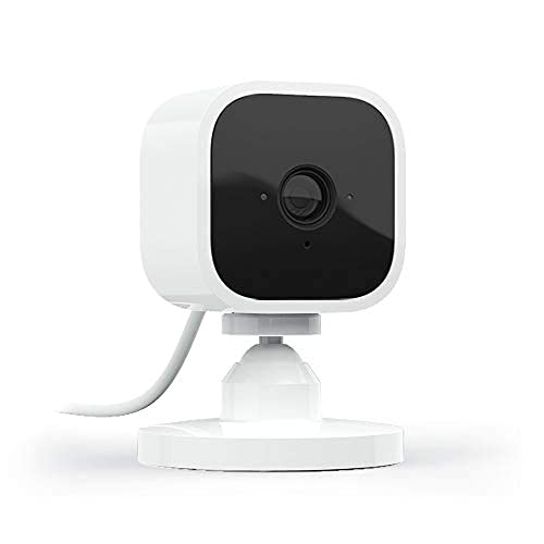 Compact white indoor security camera with a black front, featuring a lens, adjustable base, and a cable for power, designed for 1080p HD video and night vision.