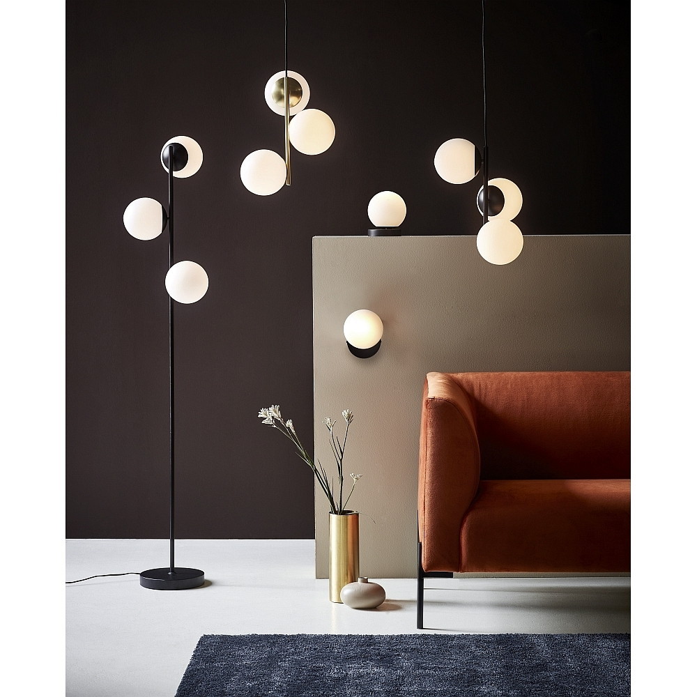 Black pendant light featuring a sleek design with a round white glass shade, hanging elegantly among other modern light fixtures in a stylish interior setting.