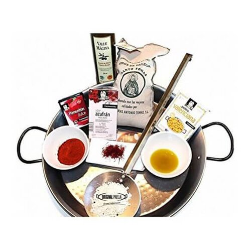 Complete paella starter set featuring a silver paella pan, saffron, paprika, rice, olive oil, and a wooden spoon, all arranged neatly for easy cooking.