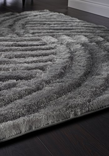 Silver plush rug measuring 160 x 230 cm, featuring a textured wave pattern and soft, thick fibers, set against a dark wooden floor.