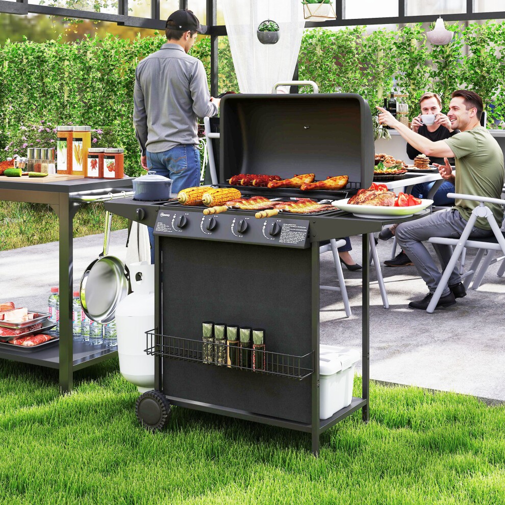 Black 5-burner gas barbecue grill with a lid, featuring a spacious cooking surface, side shelves, and a storage rack, set in a garden with people enjoying a meal.