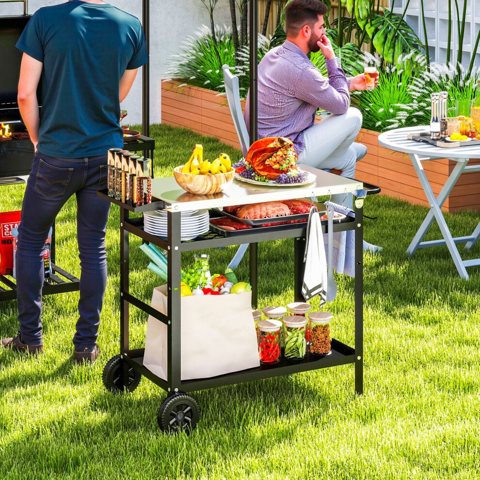Outsunny BBQ trolley featuring a stainless steel top, black frame, movable pizza table, and storage for utensils and ingredients, set in a grassy outdoor area.
