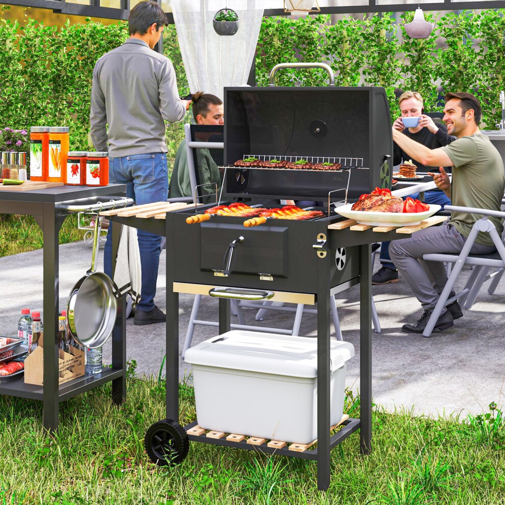 Black Outsunny charcoal BBQ grill with warming rack, three shelves, temperature gauge, and side tables, set in a garden with people enjoying a meal.