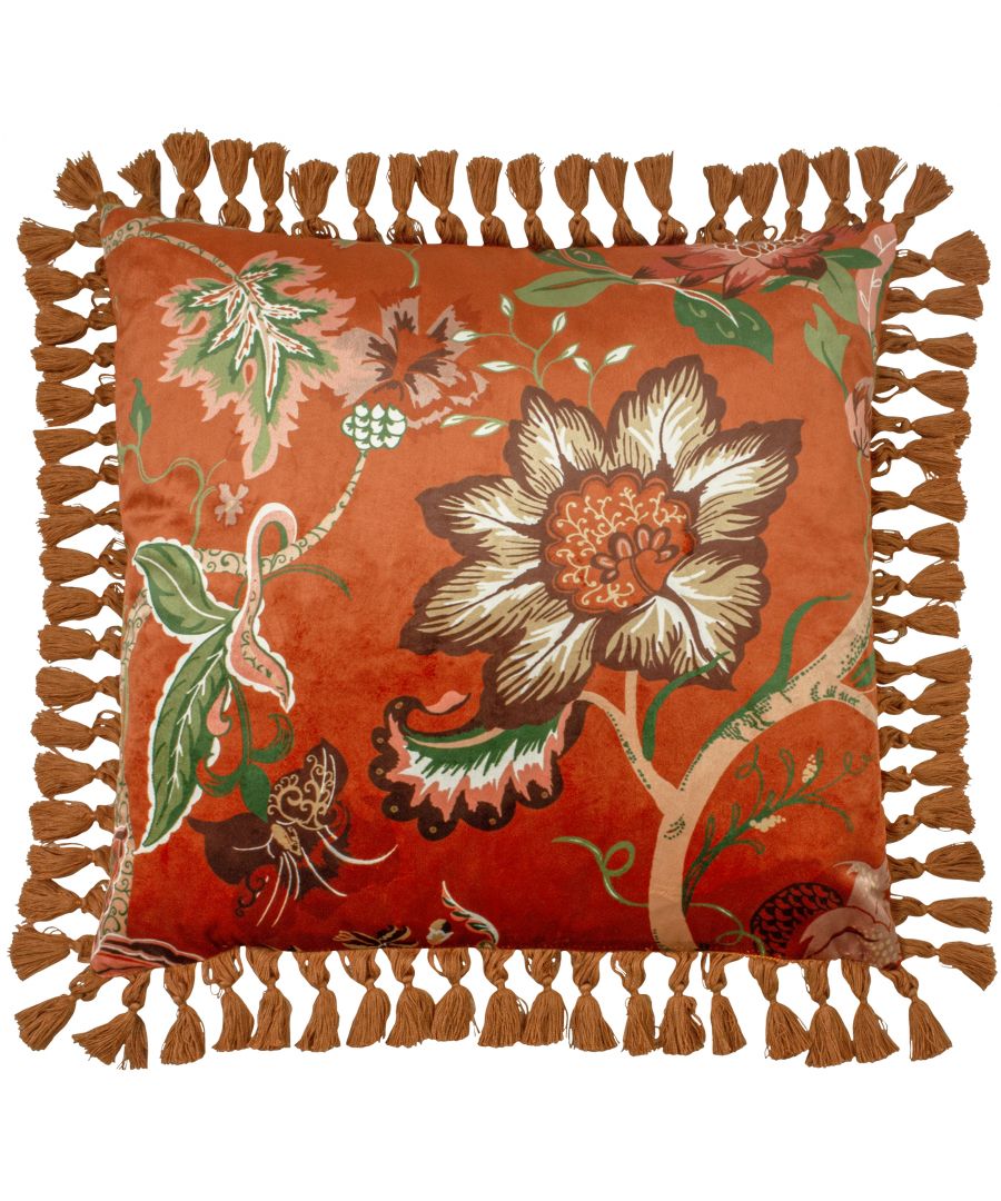Rust-colored cushion featuring a floral design with green and cream accents, bordered by a decorative tassel trim, measuring 50 cm x 50 cm.