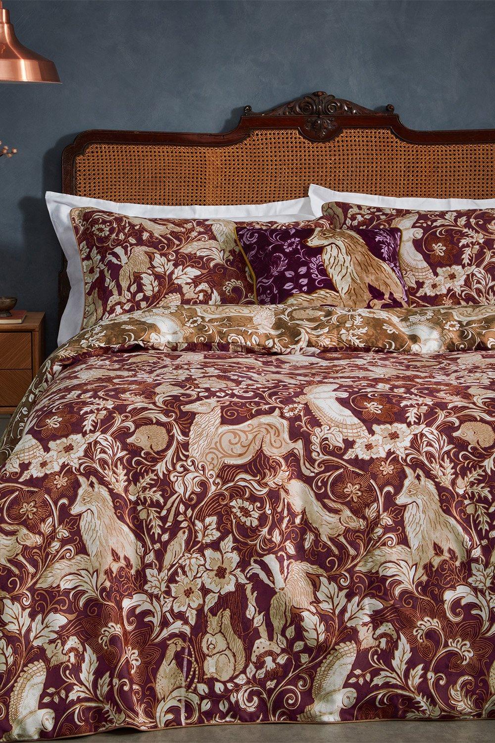 Red 100% cotton duvet cover set featuring intricate British animal designs, complemented by white and purple accents, suitable for a king-sized bed.
