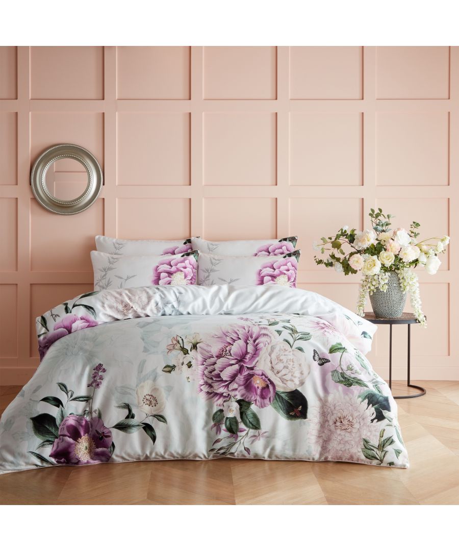 Super King duvet cover set featuring a cotton fabric with a vibrant floral design in shades of purple, pink, and green, complemented by matching pillowcases and a soft sheen.