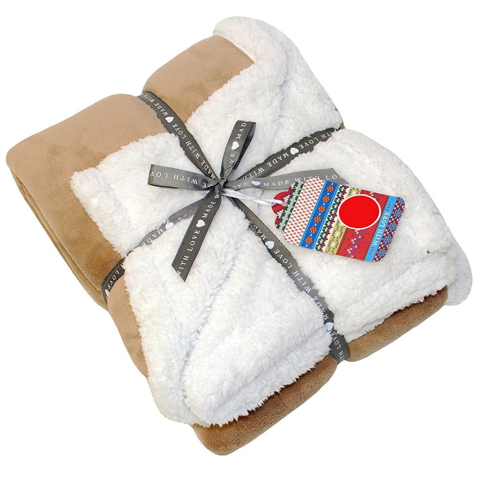 Lux Sherpa fleece throw in cream and tan, featuring a soft, plush texture, neatly folded and tied with a decorative ribbon and tag.