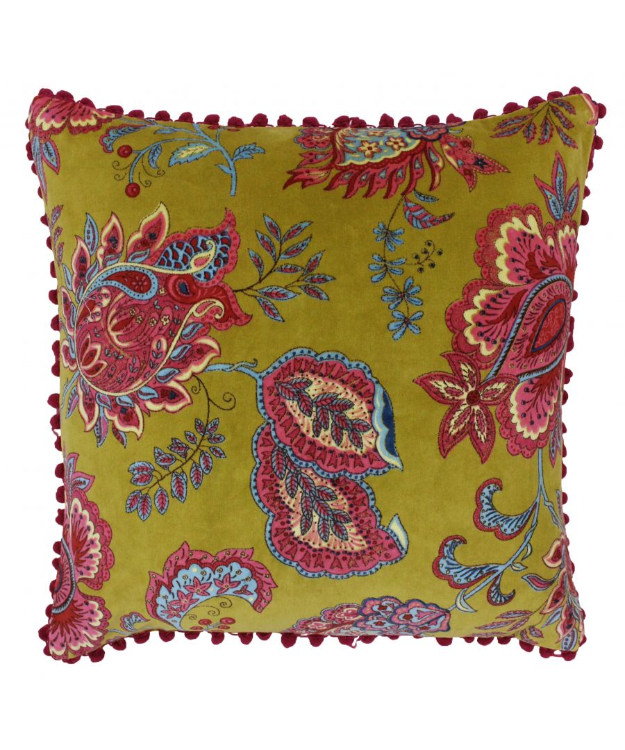 Yellow paisley velvet cushion featuring vibrant floral patterns in red and blue, accented with a decorative pom-pom trim around the edges.