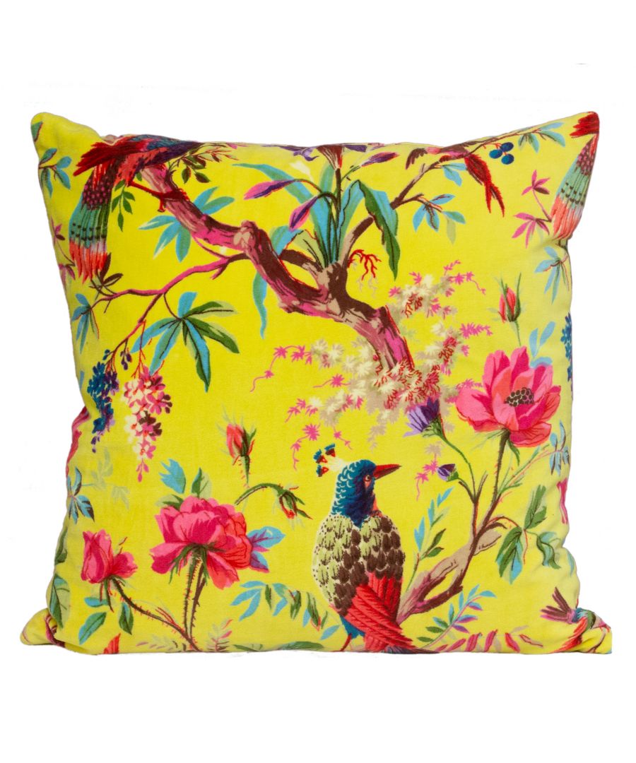 Bright yellow velvet cushion featuring a vibrant nature print with colorful flowers and exotic birds, showcasing intricate details and a luxurious texture.