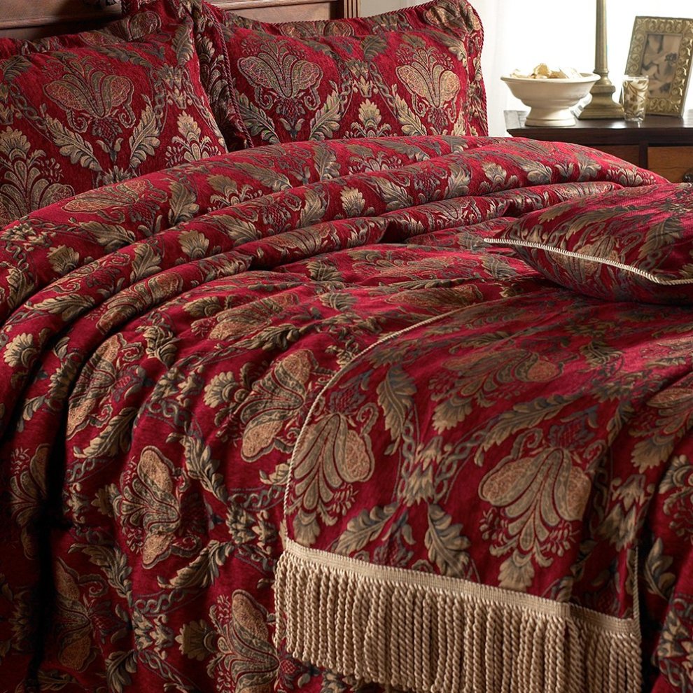Burgundy jacquard throw with intricate floral patterns and fringed edges, made of soft fabric, perfect for adding elegance to bedding or decor.