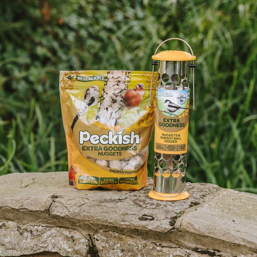 Peckish Wild Bird Extra Goodness Feeder and Nuggets, featuring a resealable bag in vibrant colors and a metallic feeder with a yellow top and holes for bird access, set against a natural background.