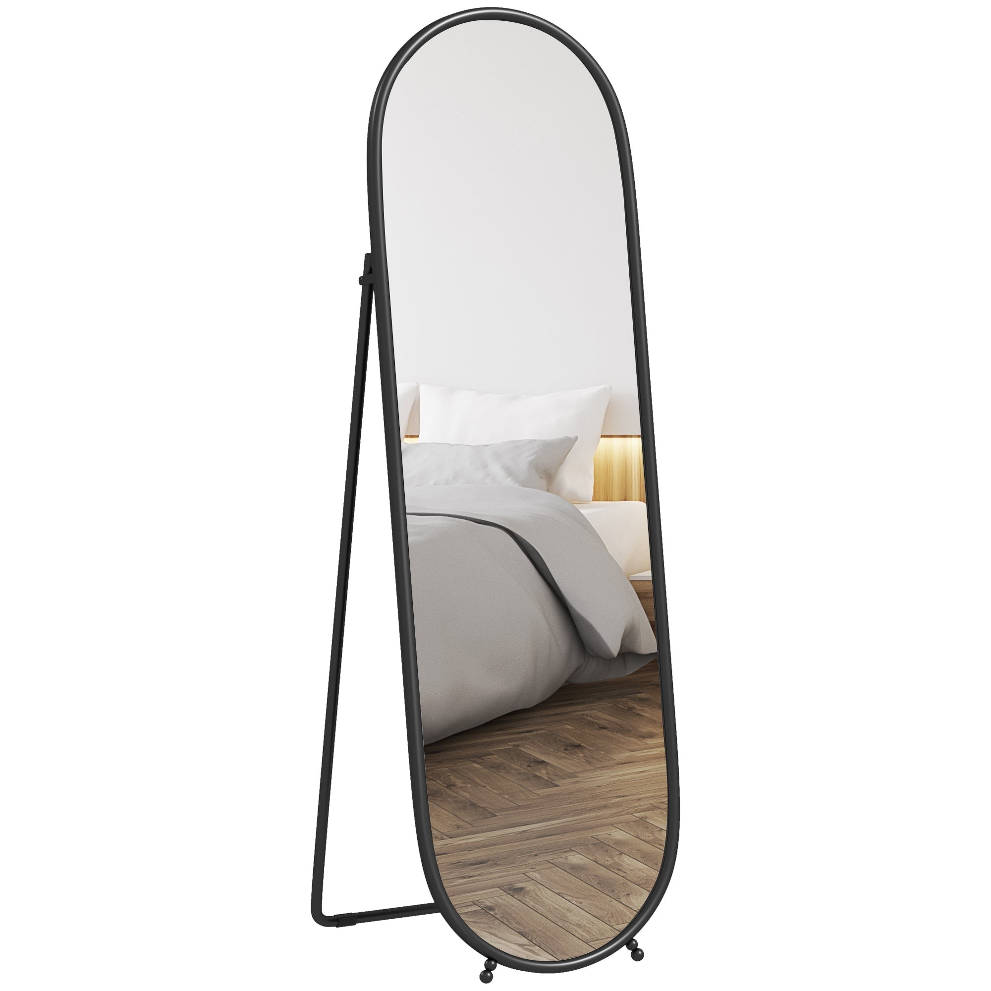 Oval full-length mirror with a sleek black metal frame, designed for hanging or leaning, reflecting a softly lit room with a bed and neutral bedding.