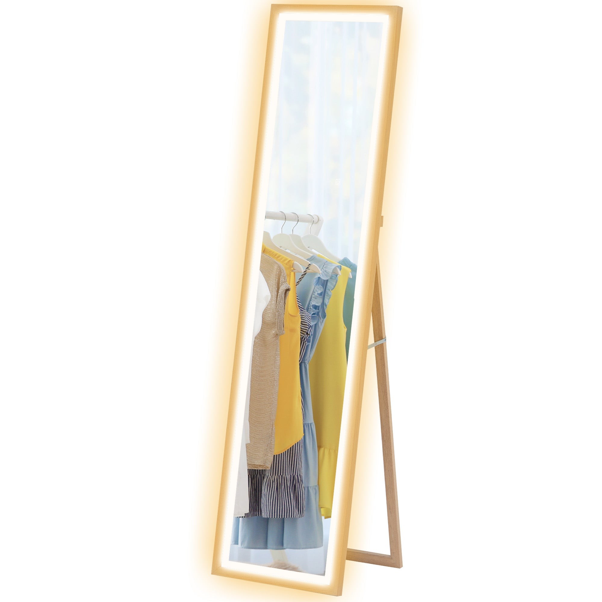 Dimming full-length mirror with a light oak frame, featuring built-in LED lights, leaning against a wall, reflecting colorful clothing on hangers.