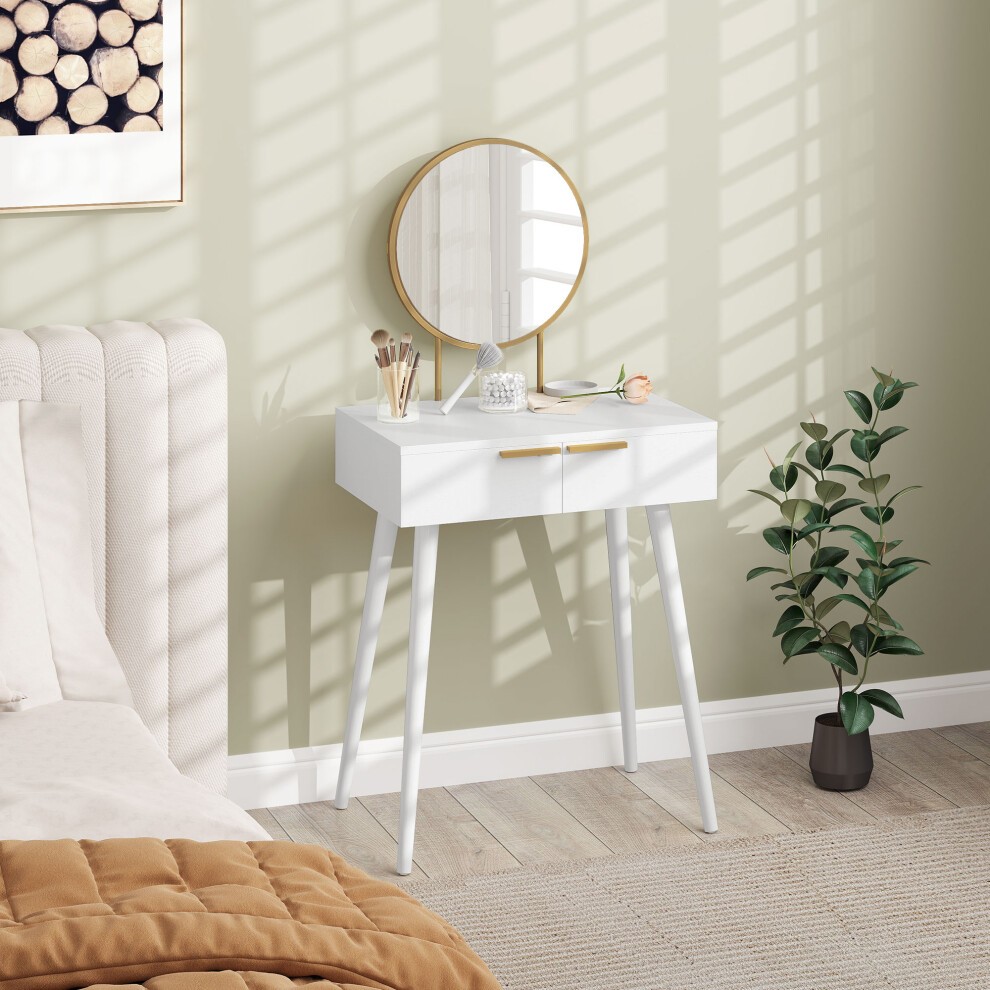 Modern white dressing table with two drawers, round mirror with a gold frame, placed beside a bed, featuring a plant and decorative items on the tabletop.