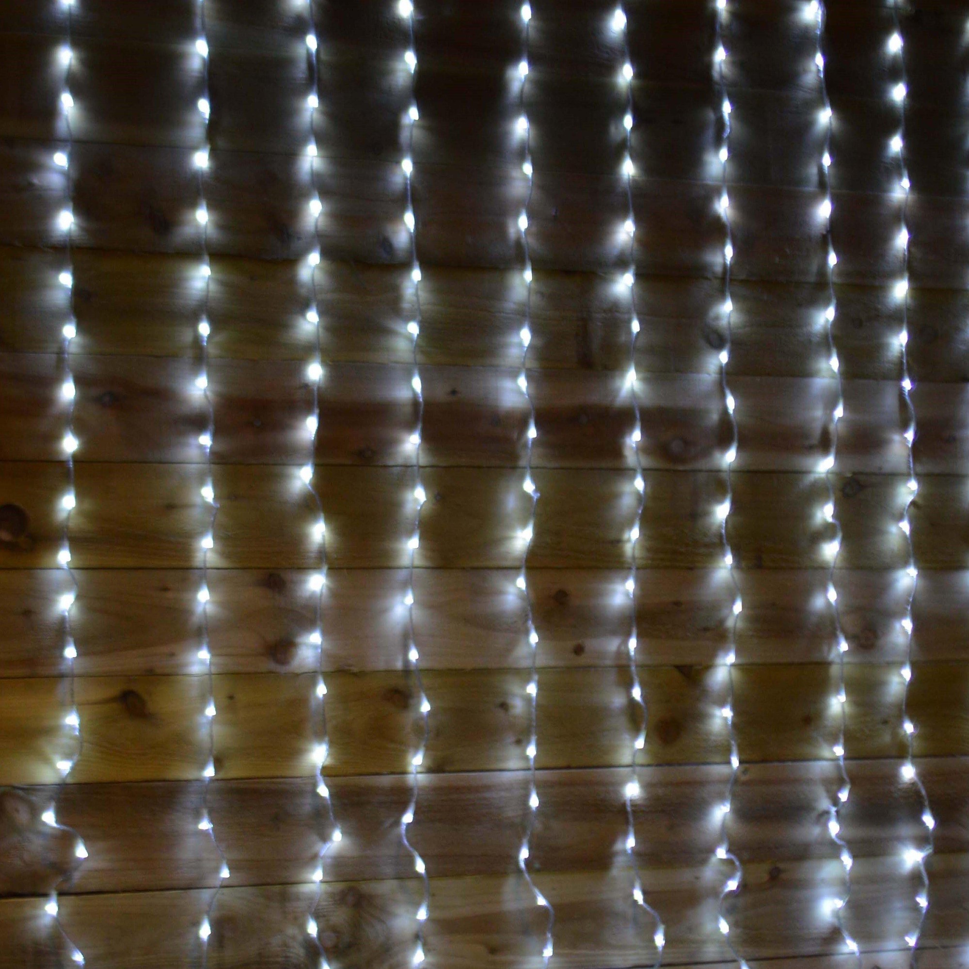 Cool white LED curtain lights in a cascading waterfall design, featuring 240 individual lights arranged in 1.5M x 2M dimensions, suitable for decorative lighting.
