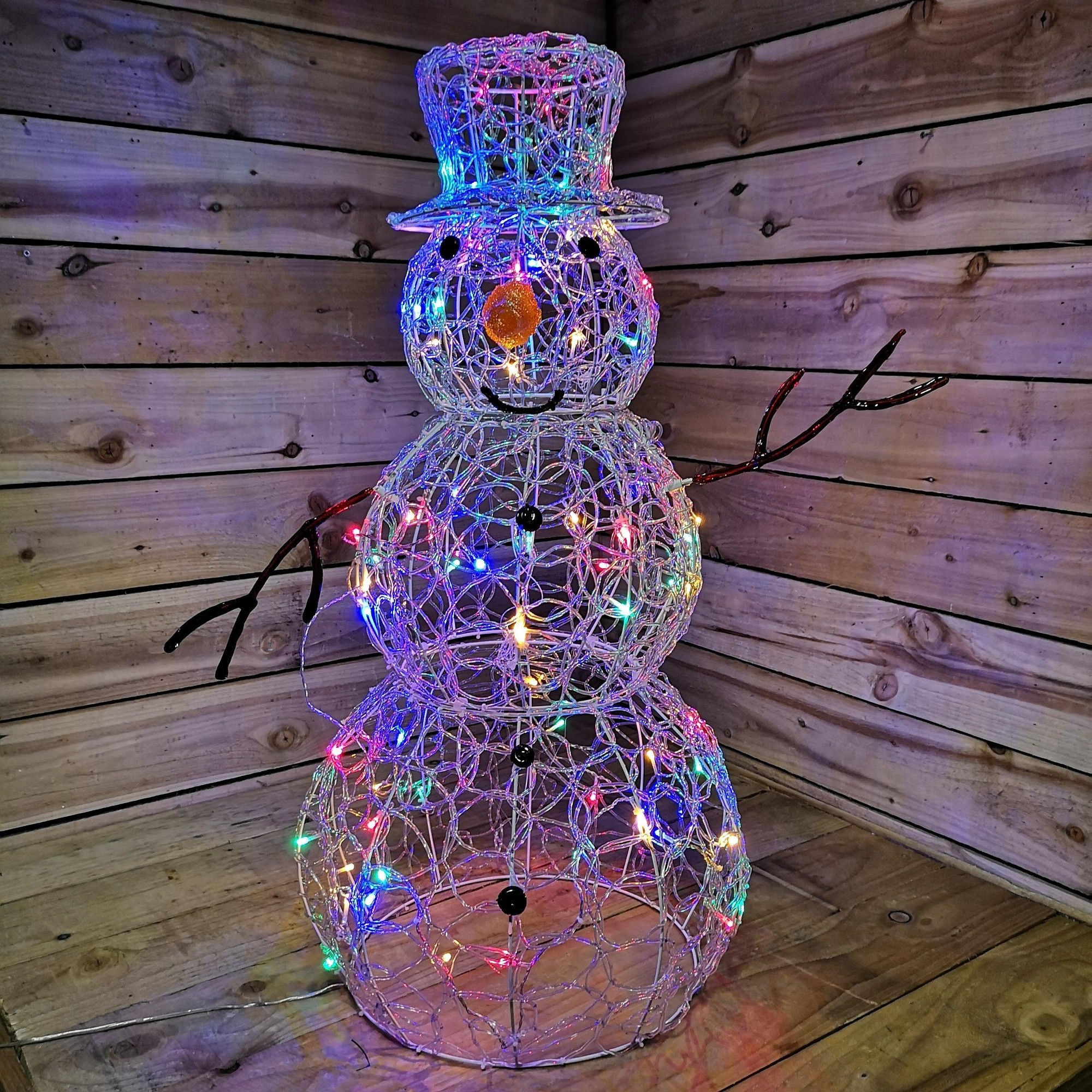 90cm tall soft acrylic Christmas snowman featuring a lit design with 80 multi-colored LED lights, a top hat, orange nose, and black twig-like arms against a wooden backdrop.