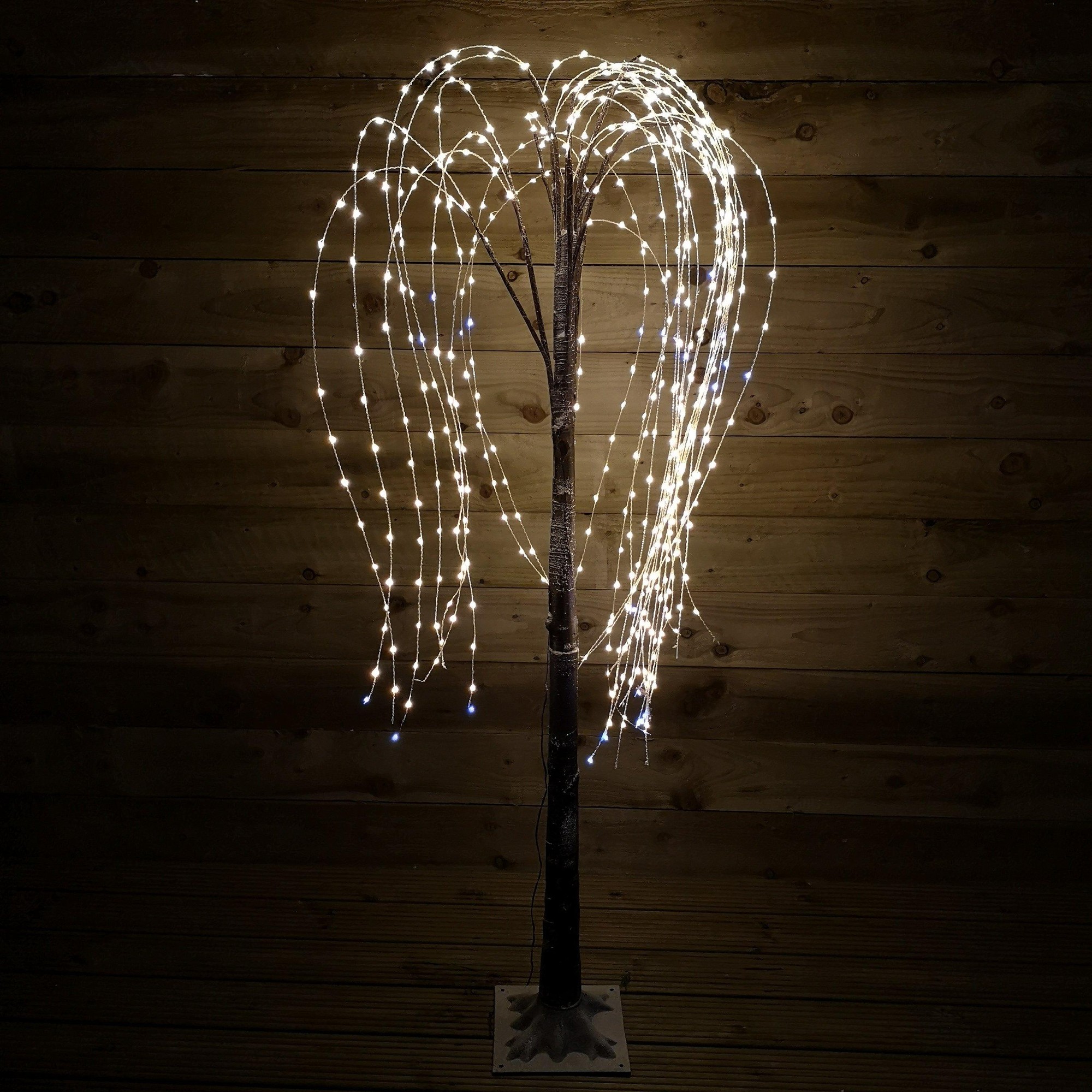 5ft brown flocked willow tree with 540 LED lights in a white mix, featuring static and flashing options, set against a wooden background.
