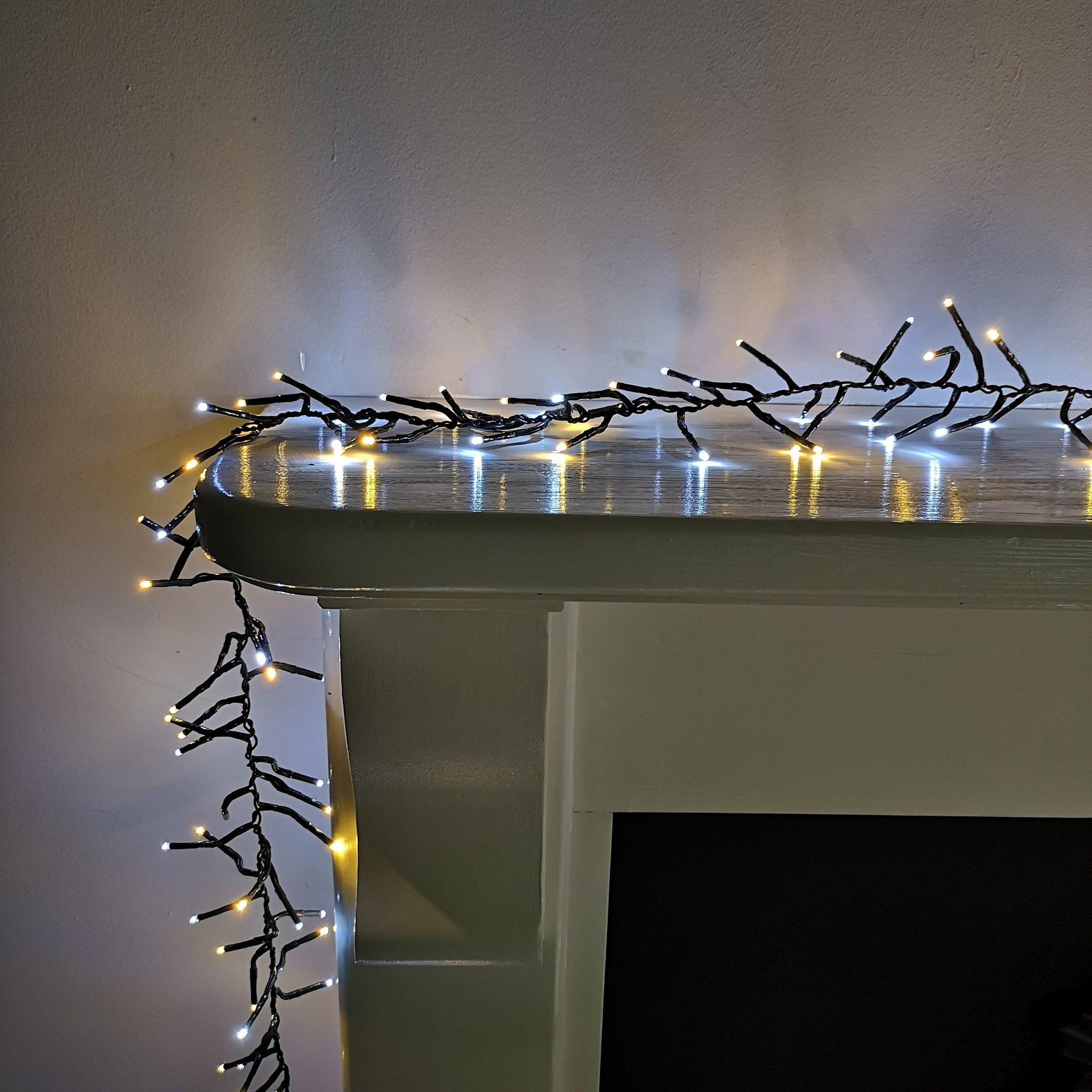 Premier Samuel Alexander 960 LED Christmas cluster lights featuring cool white and warm white bulbs on a black wire, designed for indoor and outdoor use with a timer function.