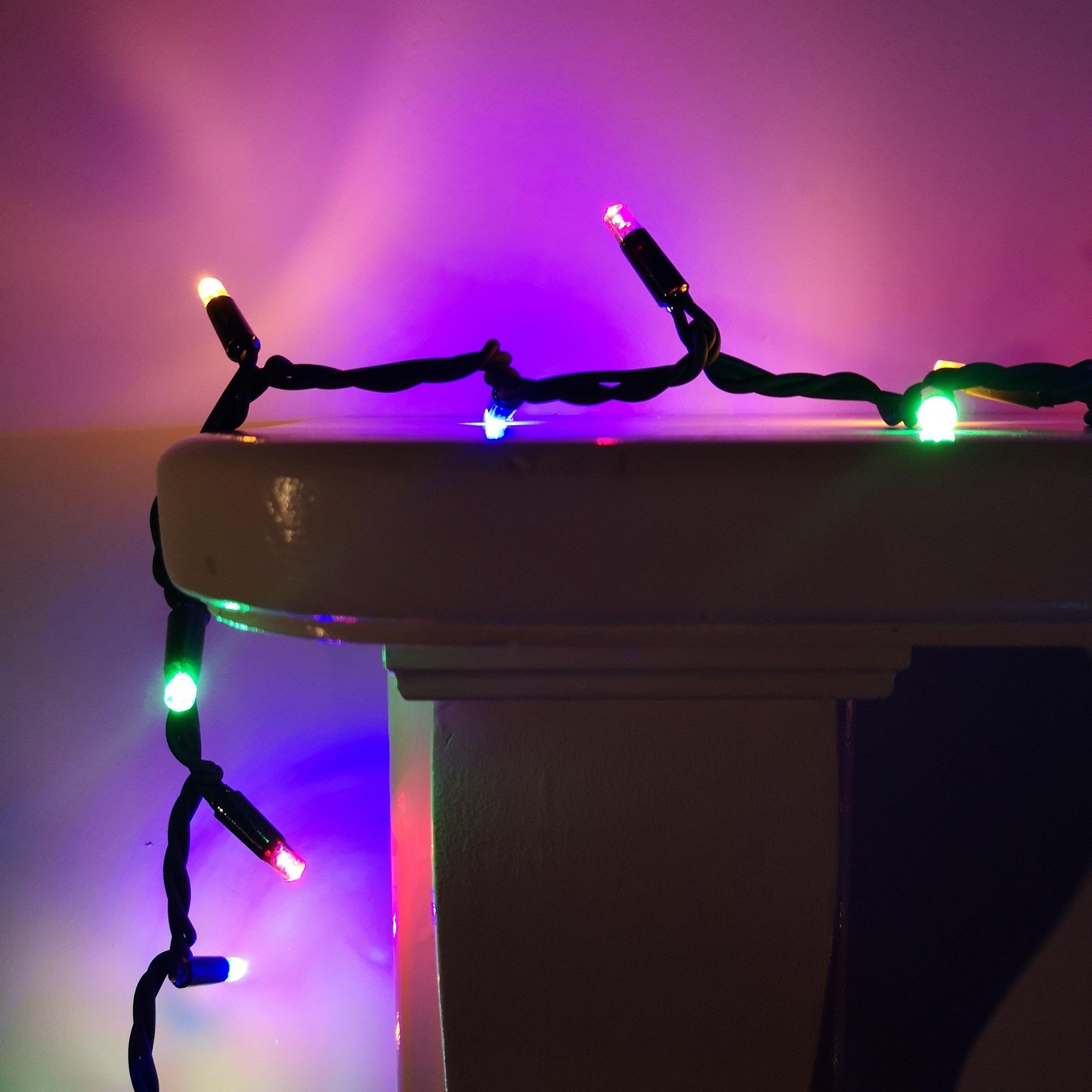 100 LED multicoloured outdoor Christmas lights, featuring a black cable with vibrant green, blue, red, and yellow bulbs, designed for connectable static display.
