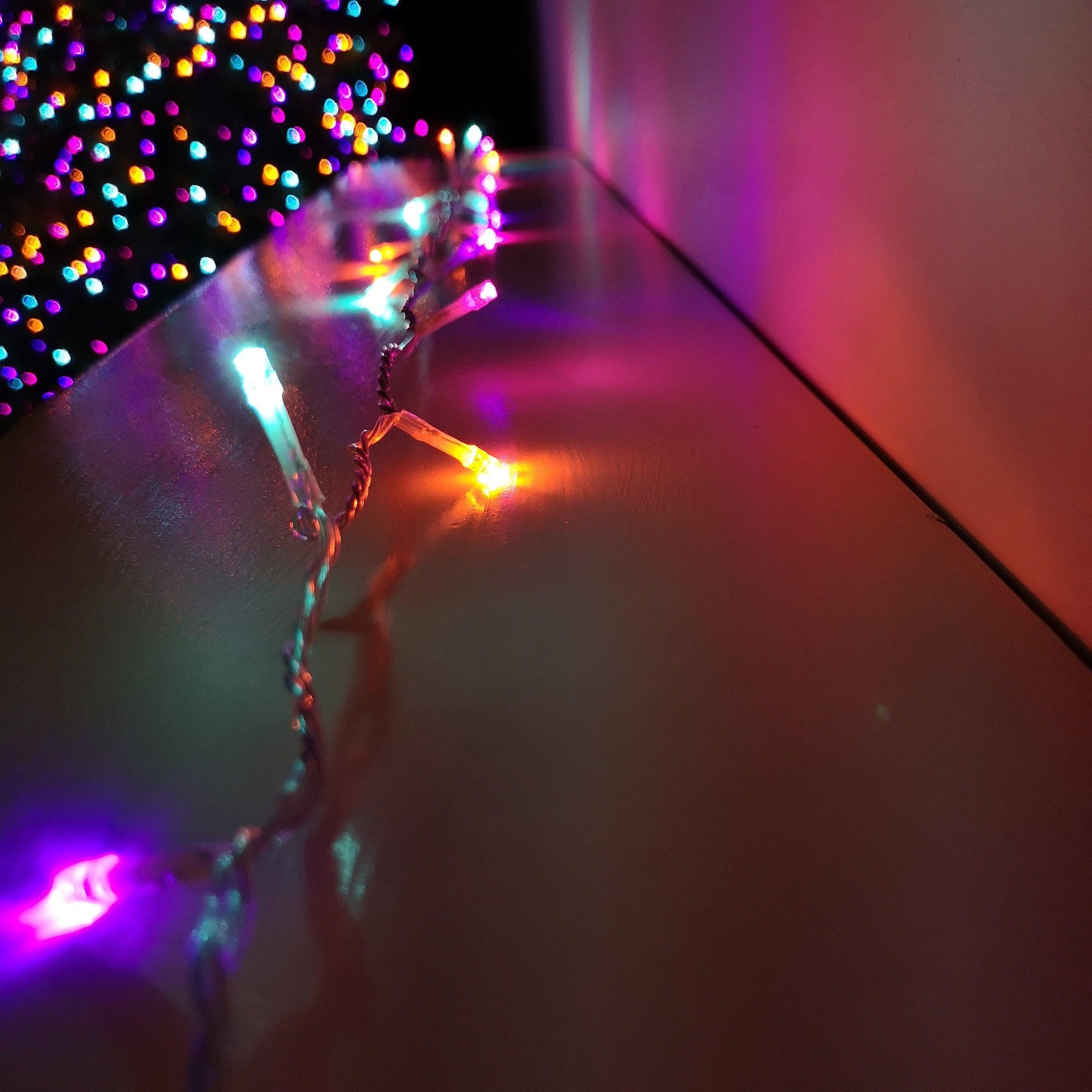 200 LED outdoor Christmas lights with a clear cable, featuring vibrant rainbow colors, twinkling effects, and a timer function, set against a softly lit background.