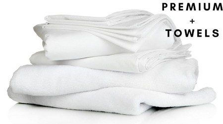 Premium full bedding pack featuring crisp white pillow, duvet, pillowcase, duvet cover, and fitted sheet, complemented by soft white towels, all made from high-quality materials.