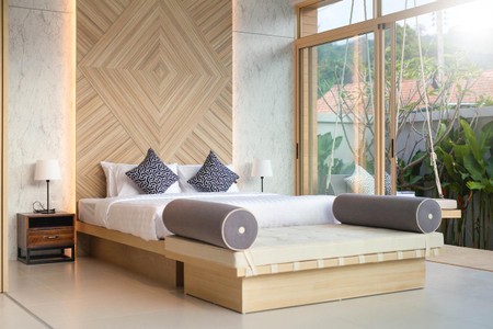 Premium bedding pack in white with black patterned accents, includes a pillow, duvet, pillowcase, duvet cover, fitted sheet, and towels, displayed on a modern wooden bed in a stylish room.