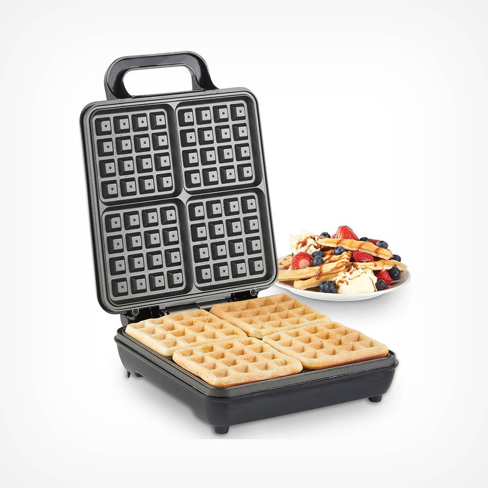 Black VonShef Quad Waffle Maker with a textured cooking surface, featuring four square waffle sections, alongside a plate of waffles topped with berries and syrup.