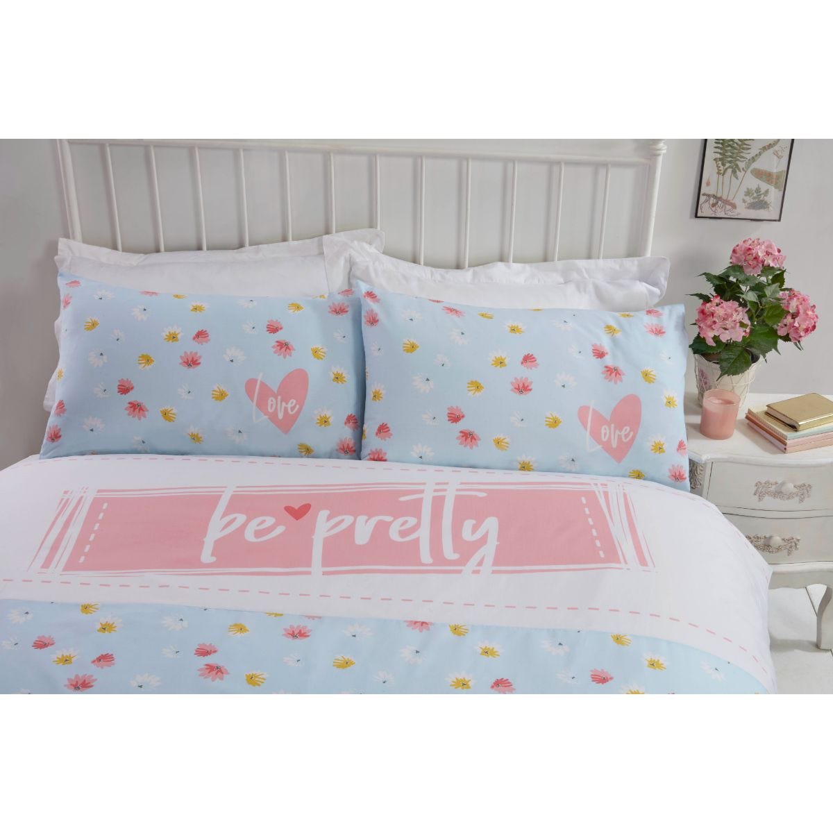 Duck egg blue duvet set featuring a playful "be pretty" slogan, adorned with colorful floral patterns, complemented by matching pillowcases with heart accents.