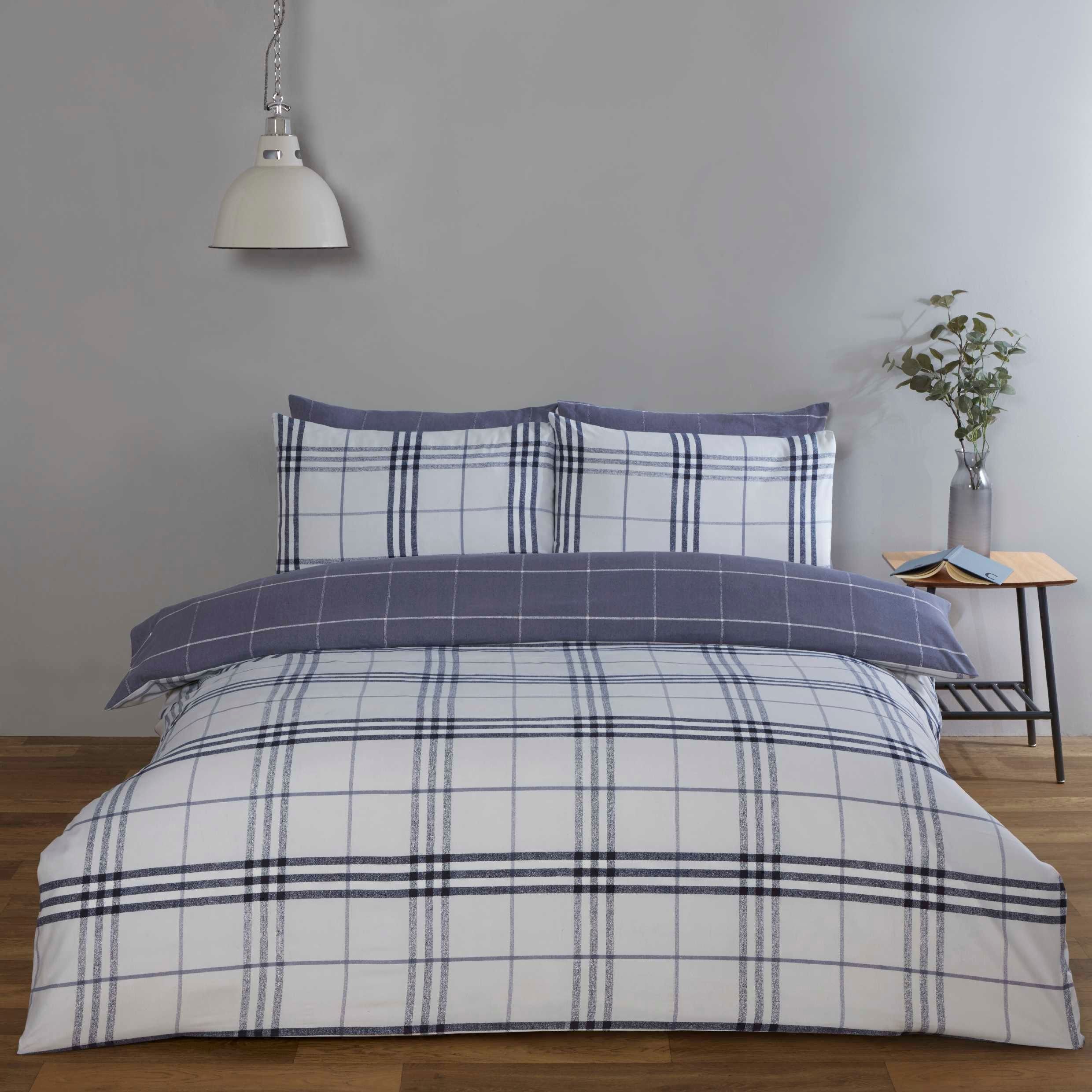 King-sized duvet set in denim blue featuring a classic check pattern, made from soft fabric, complemented by matching pillowcases and a stylish bedspread.