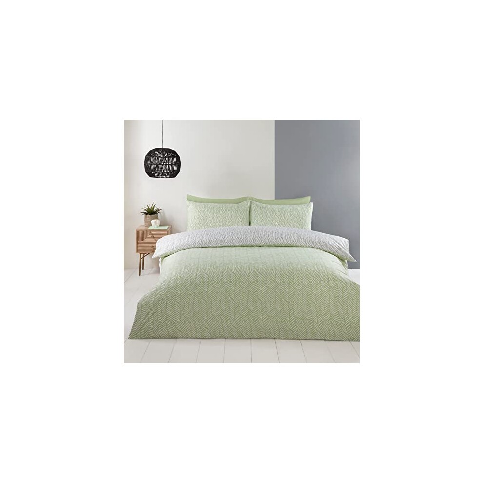 Double duvet set in green featuring a textured pattern, complemented by a light grey reverse, with matching pillowcases, styled on a bed against a minimalist backdrop.
