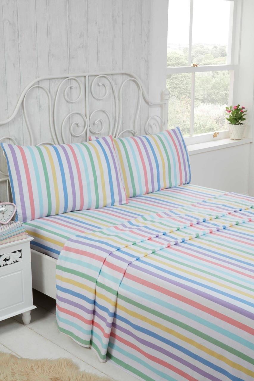 King-sized sheet set in brushed cotton featuring pastel candy stripes in pink, blue, yellow, and green, with matching striped pillowcases on a white bed frame.