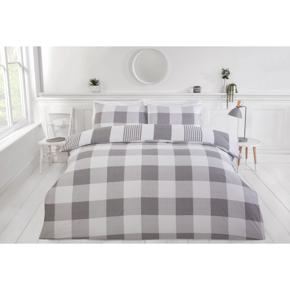 Grey king-size duvet cover set featuring a reversible chambray stripe design, with a checkered pattern in varying shades of grey, complemented by matching pillowcases.