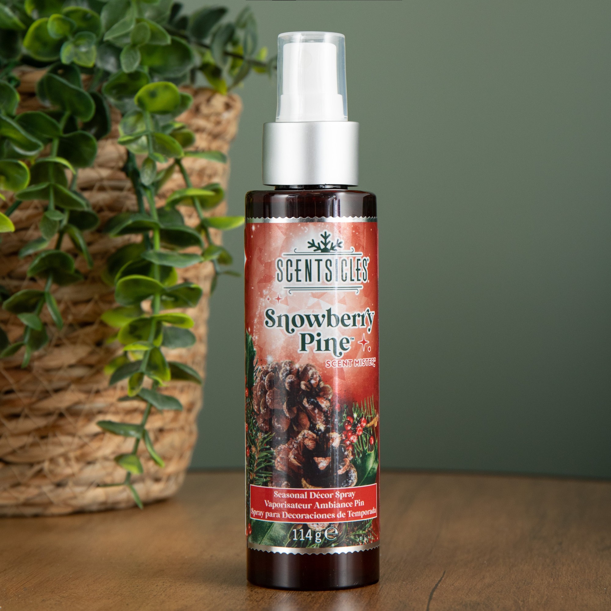 Green bottle of Samuel Alexander 114ml Snowberry Pine Scentsicles spray mist, featuring a festive label with pinecones and holiday decorations.