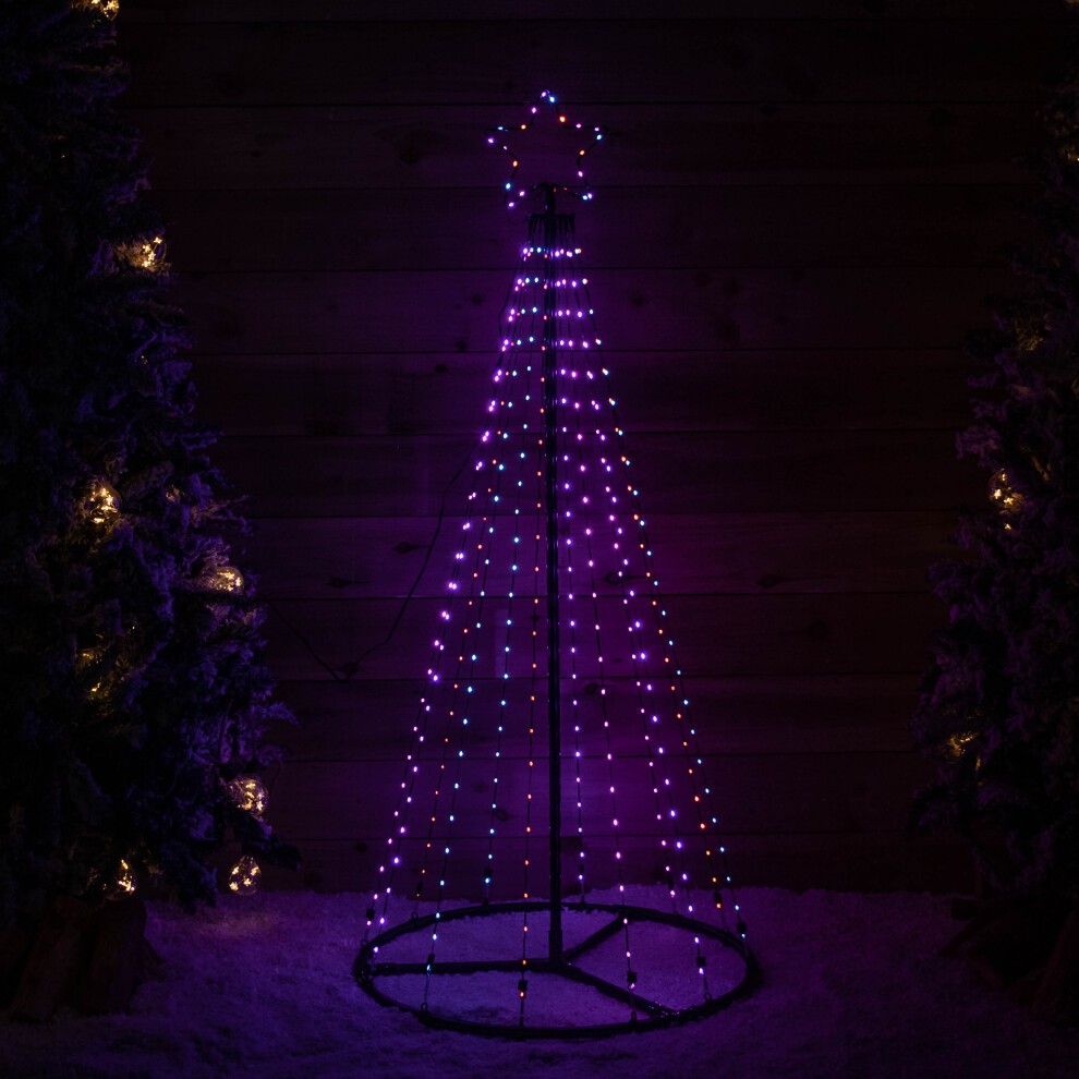 1.4m tall Christmas pyramid tree made of metal, illuminated with 308 multi-action rainbow LEDs, featuring a star on top and set against a dark wooden background.