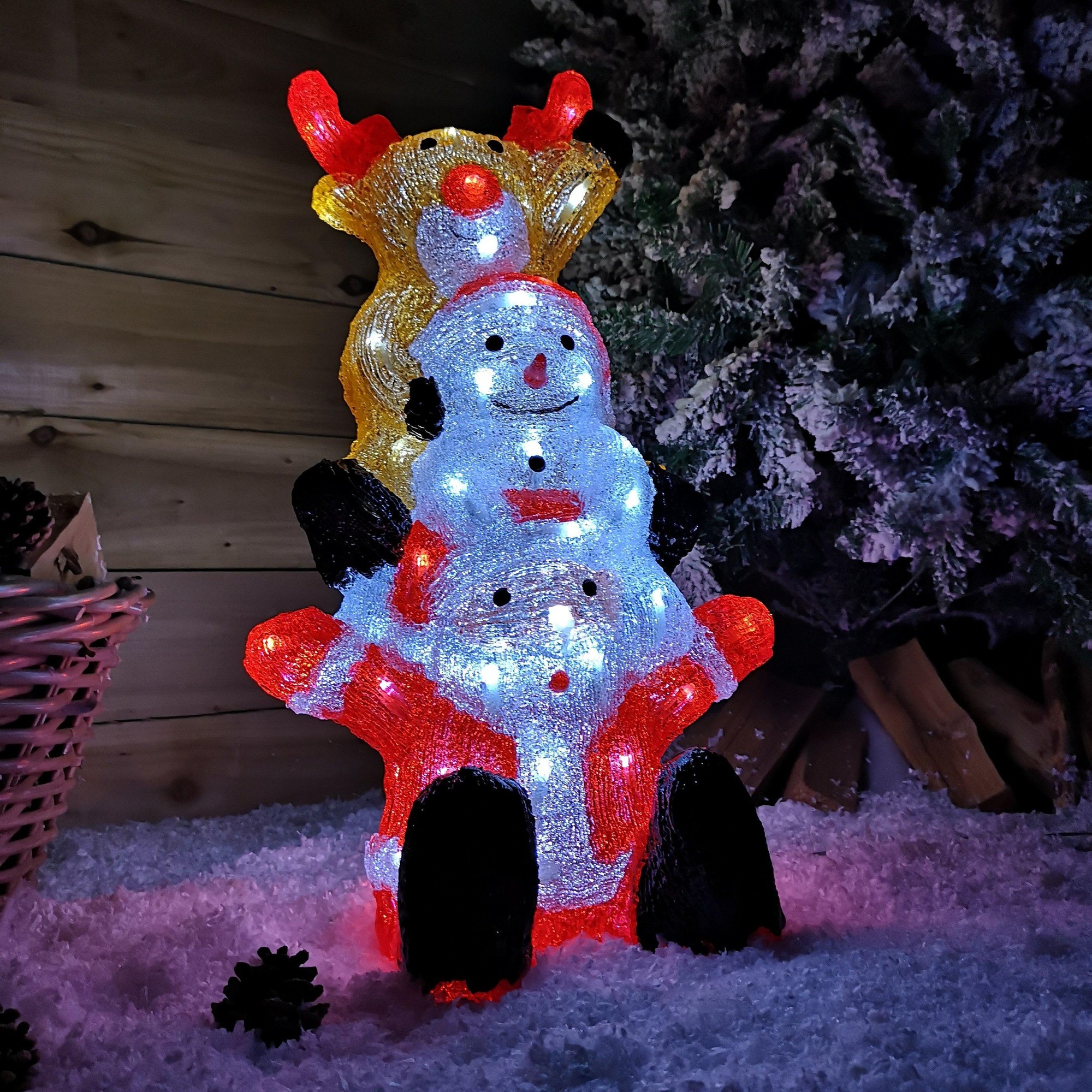 A colorful 60cm snowman and reindeer tower with 60 ice white LEDs, featuring a smiling snowman in red and white, topped by a cheerful reindeer with antlers, set against a snowy backdrop.