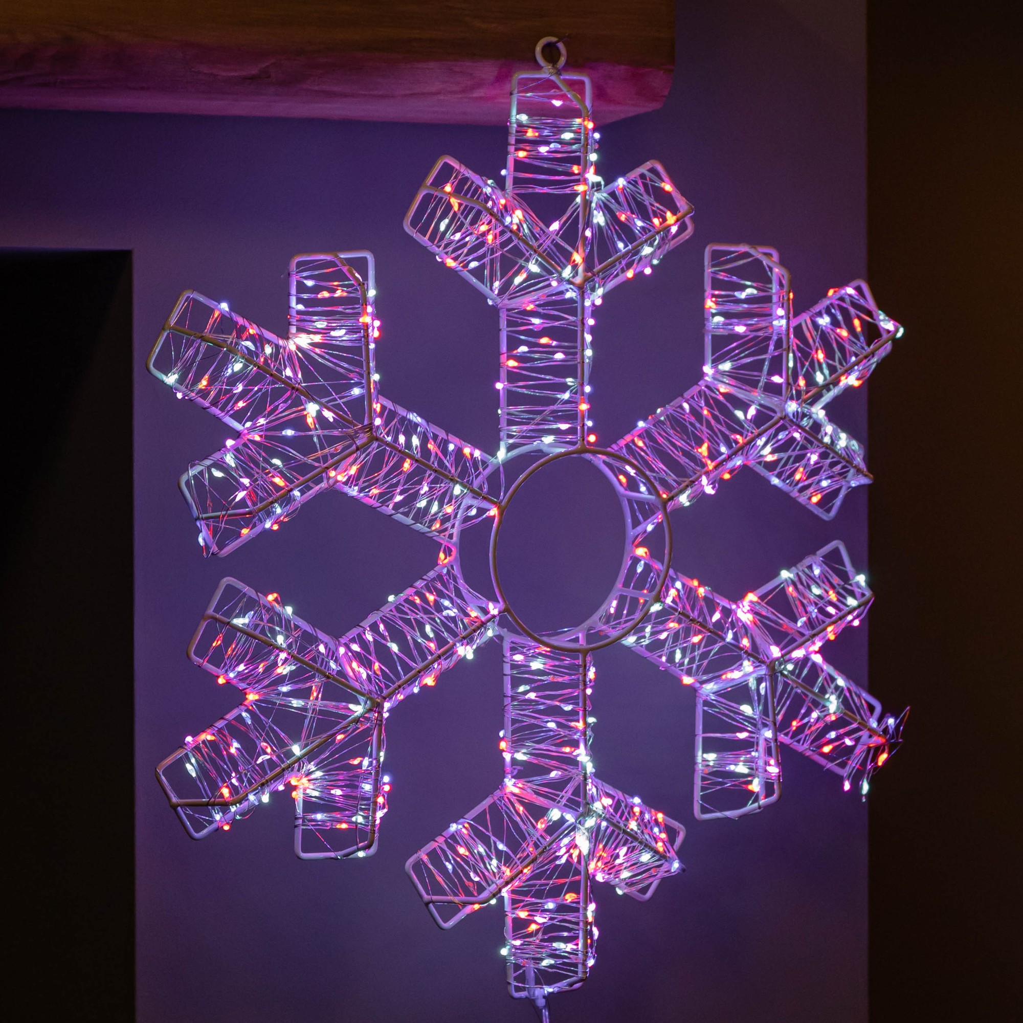 45cm white metal hanging snowflake adorned with 600 colorful rainbow LEDs, featuring a geometric design and illuminated edges, perfect for festive decoration.