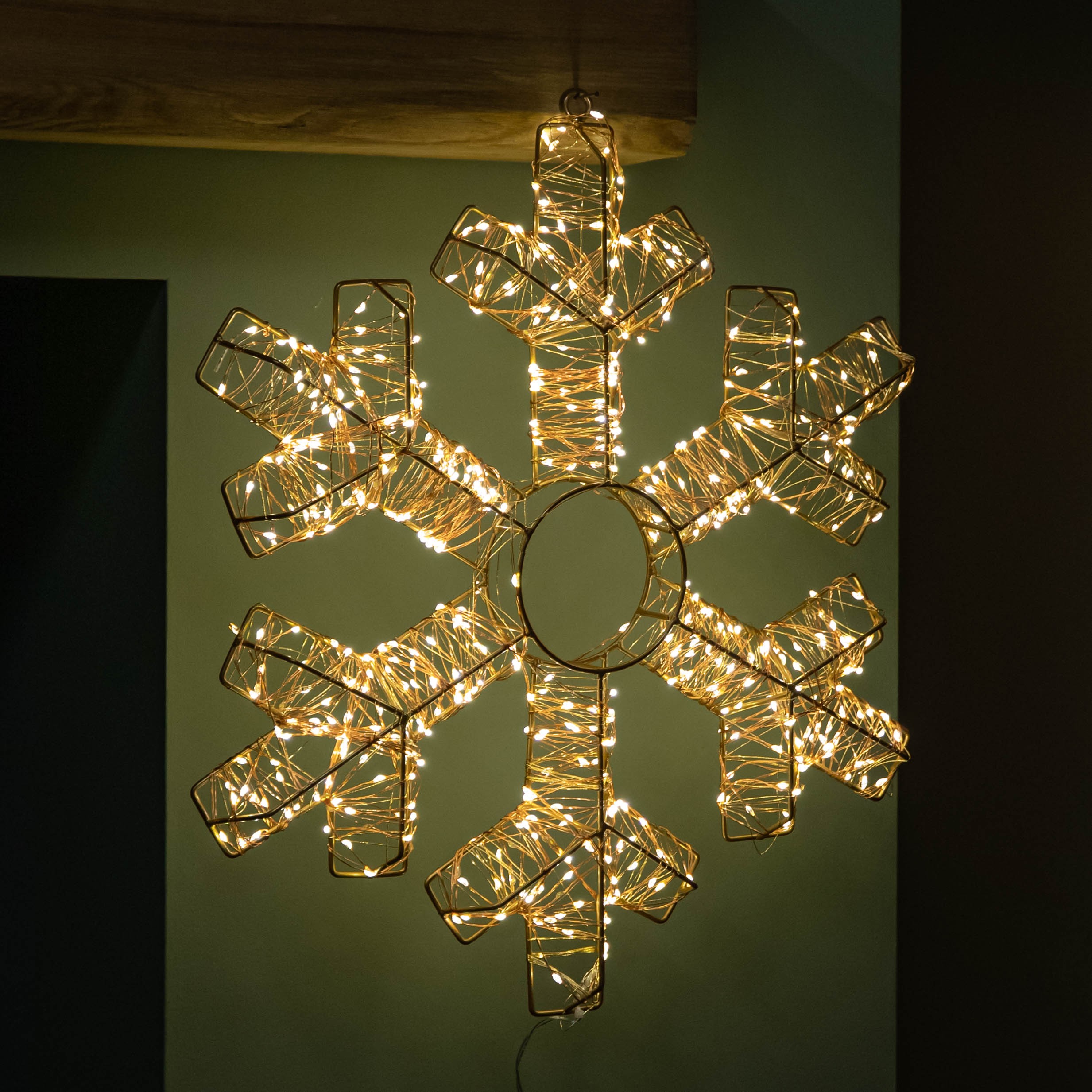 45cm rose gold metal snowflake ornament featuring 600 warm white LEDs, elegantly designed with a circular center and intricate snowflake shape, perfect for festive decor.