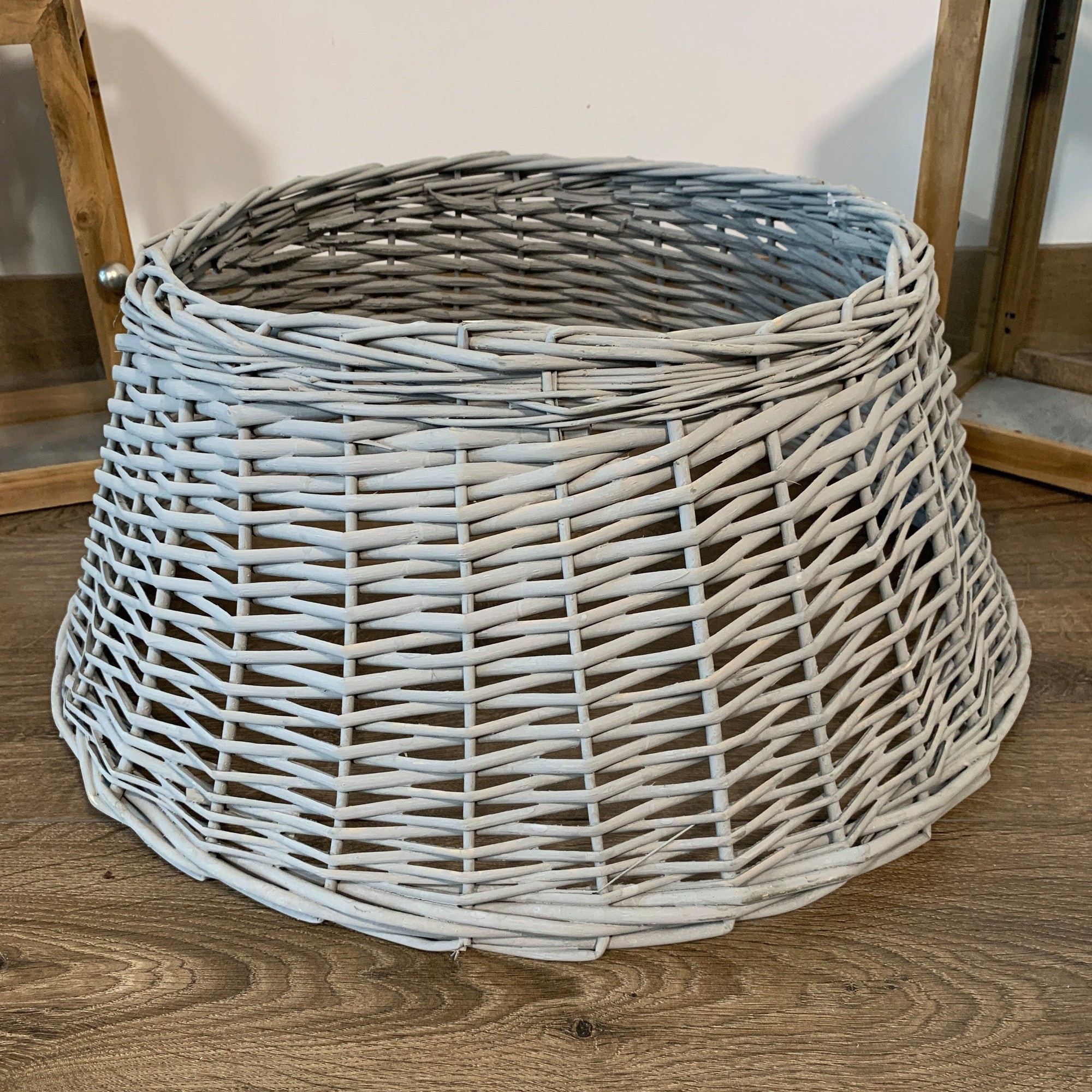 Deluxe medium light grey wicker willow Christmas tree skirt with a round shape and intricate woven design, perfect for holiday decor.