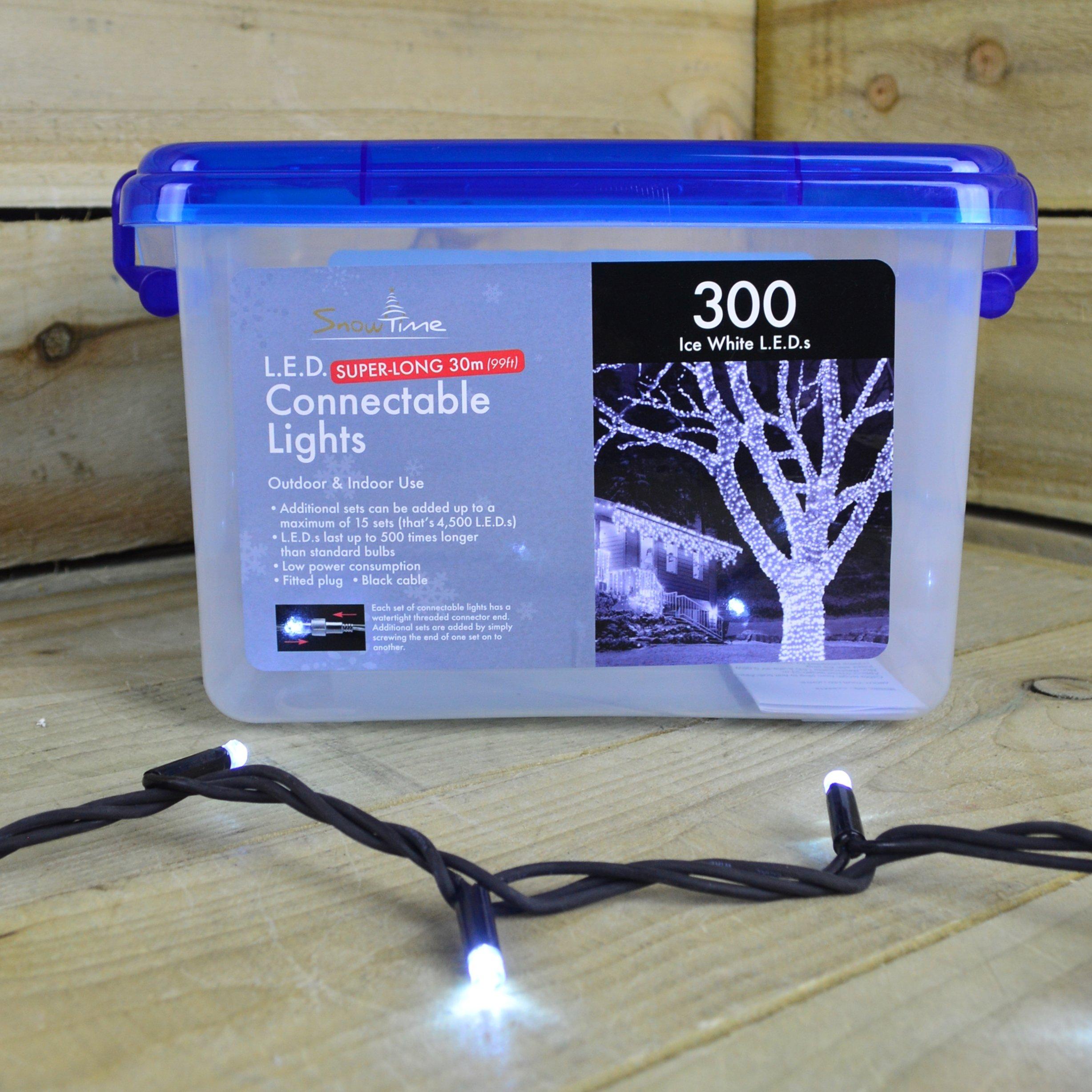300 ice white LED connectable lights on a black cable, packaged in a clear plastic container with a blue lid, suitable for indoor and outdoor use.