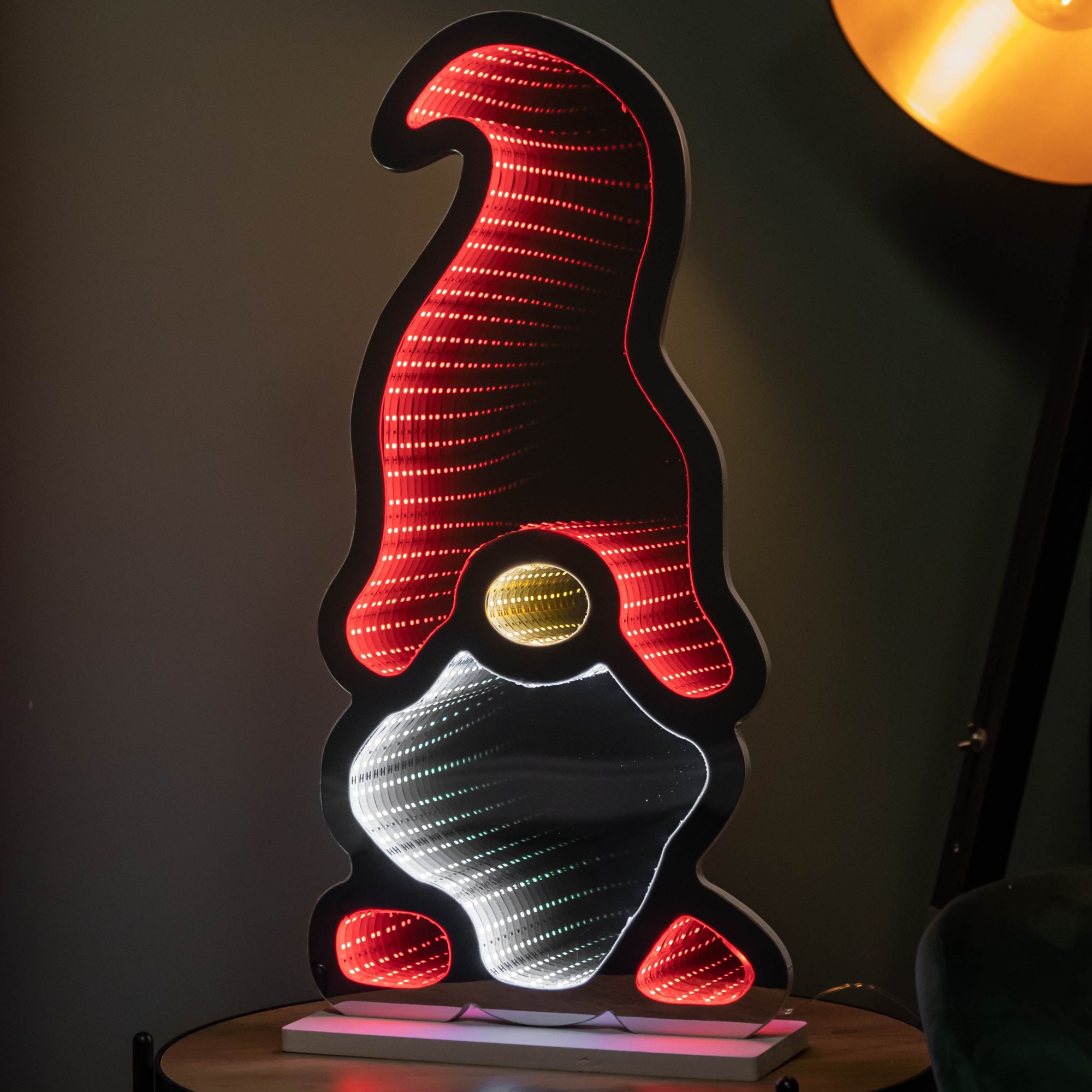 60cm light-up Christmas gonk decoration featuring a red hat, white beard, and yellow nose, illuminated with multi-coloured LEDs against a dark background.