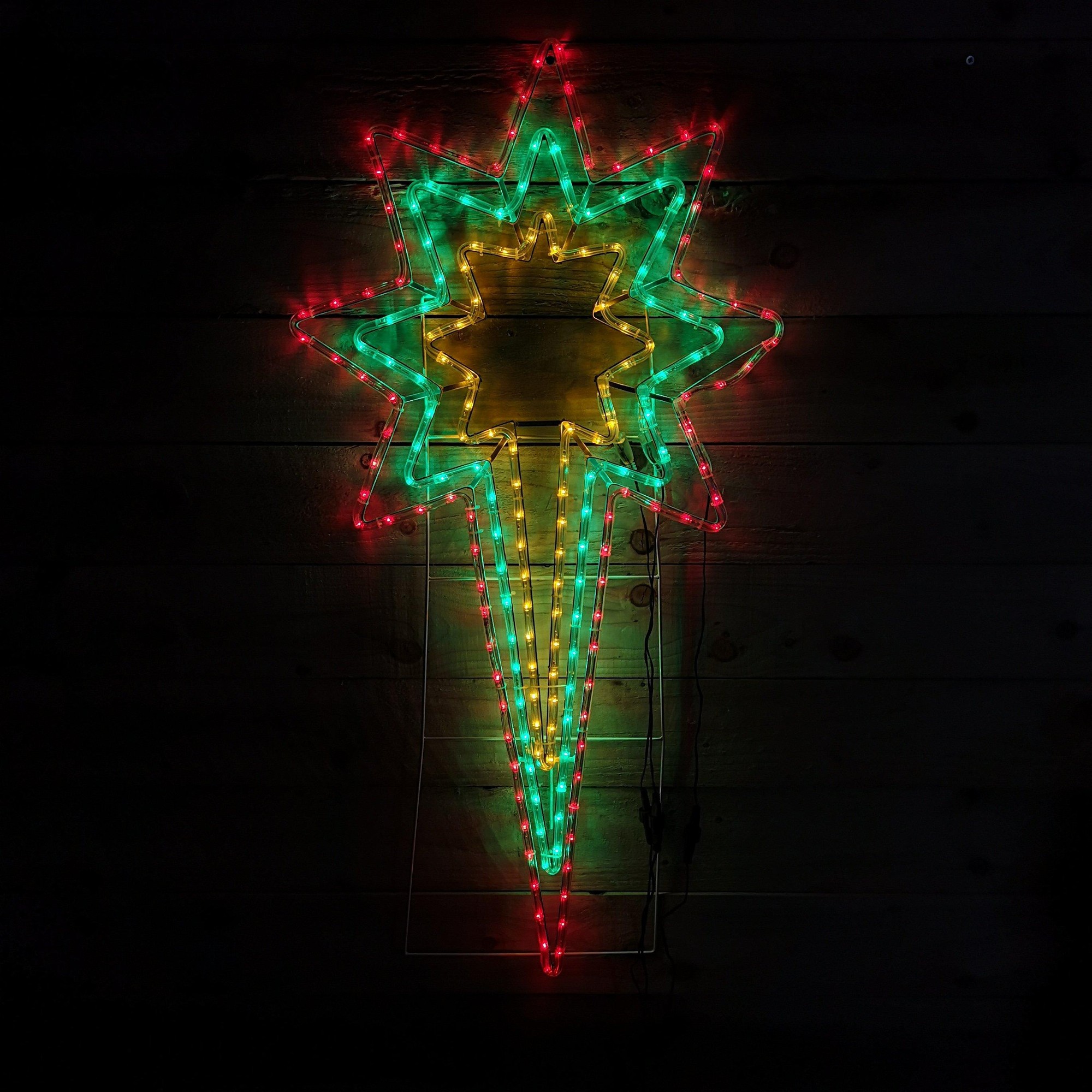 Multicoloured LED North Star silhouette light featuring green, red, and yellow lights, measuring 118 x 62cm, with a speed controller for varied lighting effects.