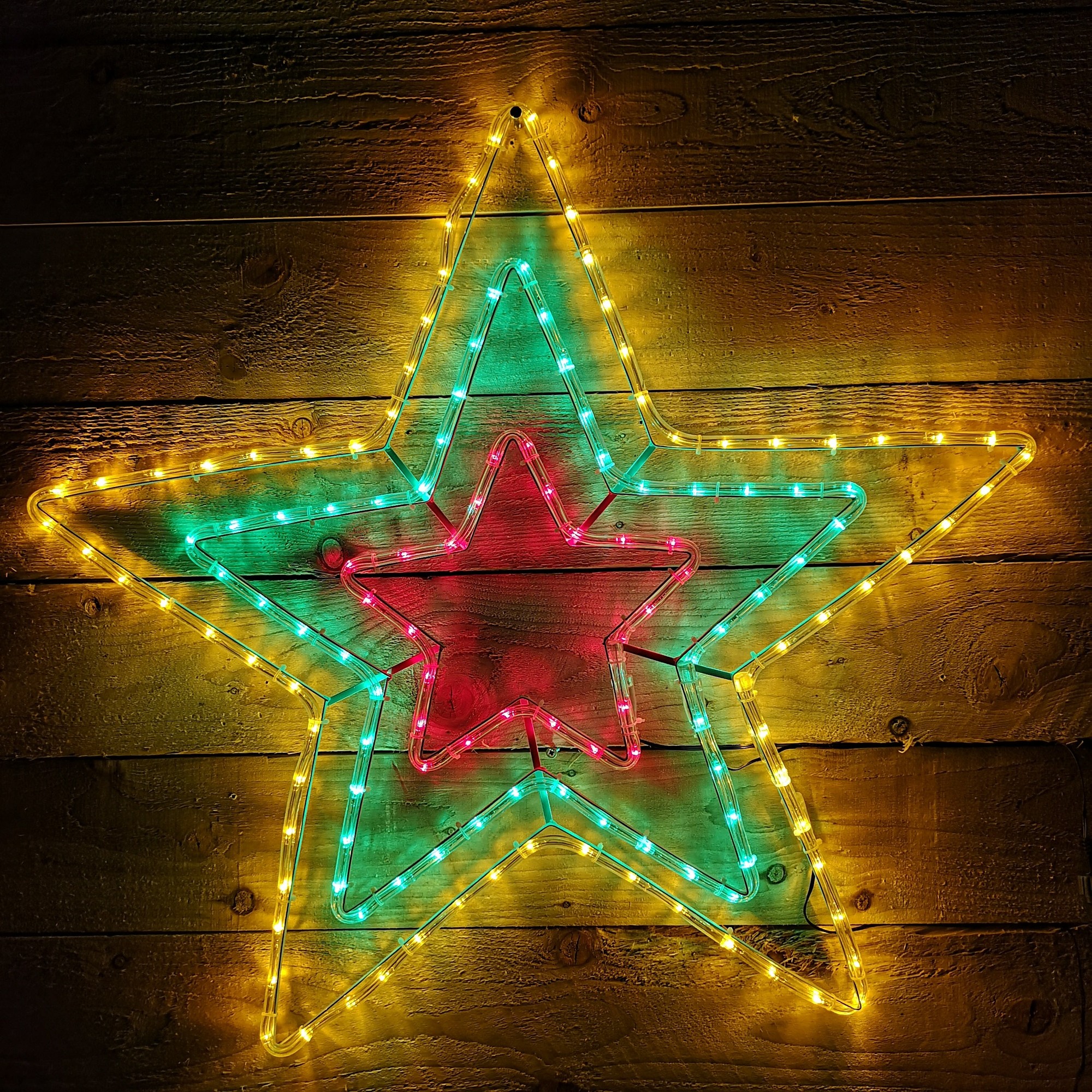 Multicoloured LED star decoration featuring three layered stars in green, red, and yellow lights, designed for indoor and outdoor Christmas displays.