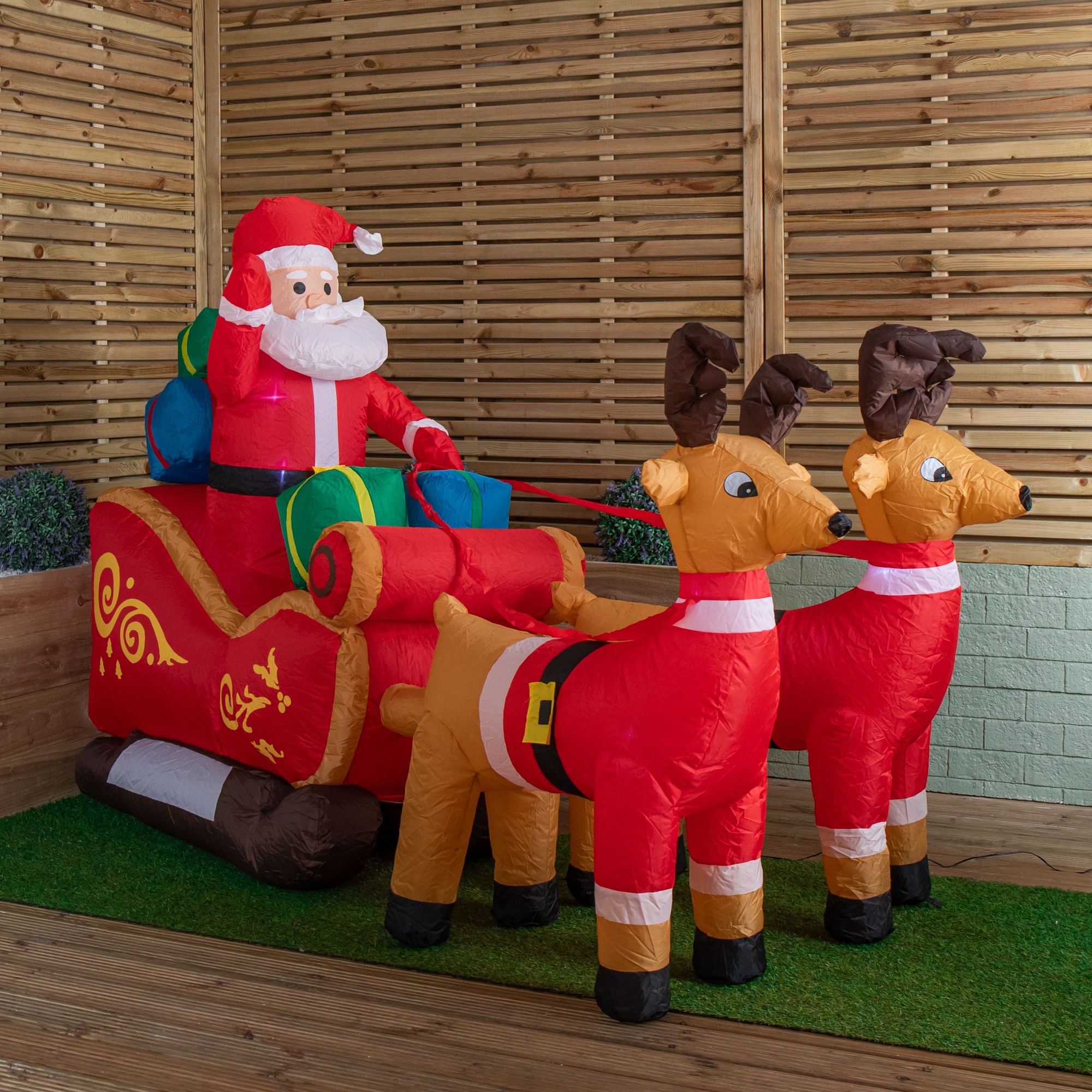 Large 8ft inflatable Christmas decoration featuring a jolly Santa in a red sleigh with colorful gifts, accompanied by two reindeer, all made of weather-resistant material.