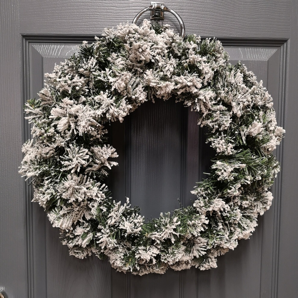 50cm green pine Christmas wreath with snow-flocked tips, featuring a lush, textured design, perfect for festive door decoration.