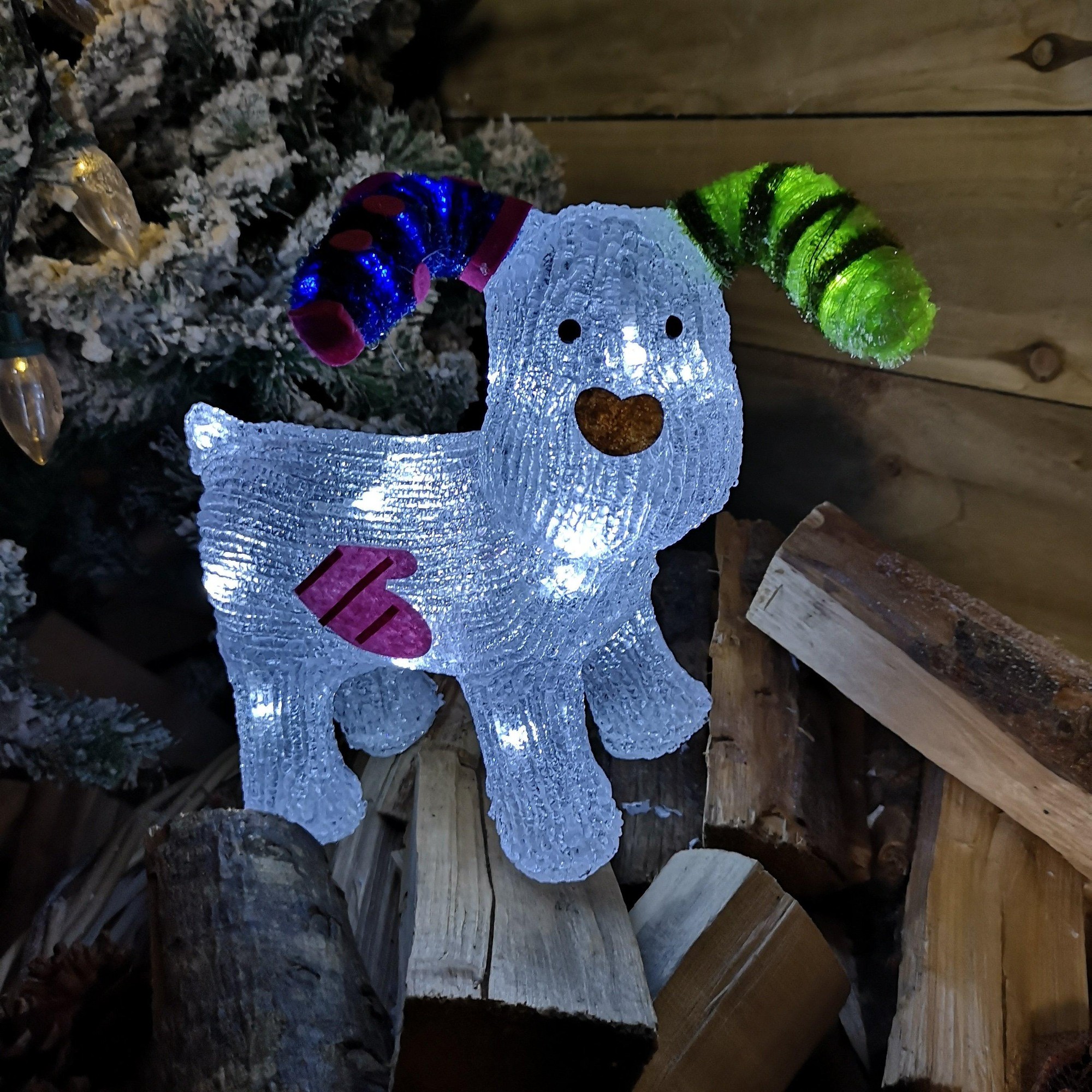 A 31cm acrylic Snowdog Christmas decoration featuring a white body, colorful striped ears, a brown nose, and 24 ice white LEDs illuminating its surface.