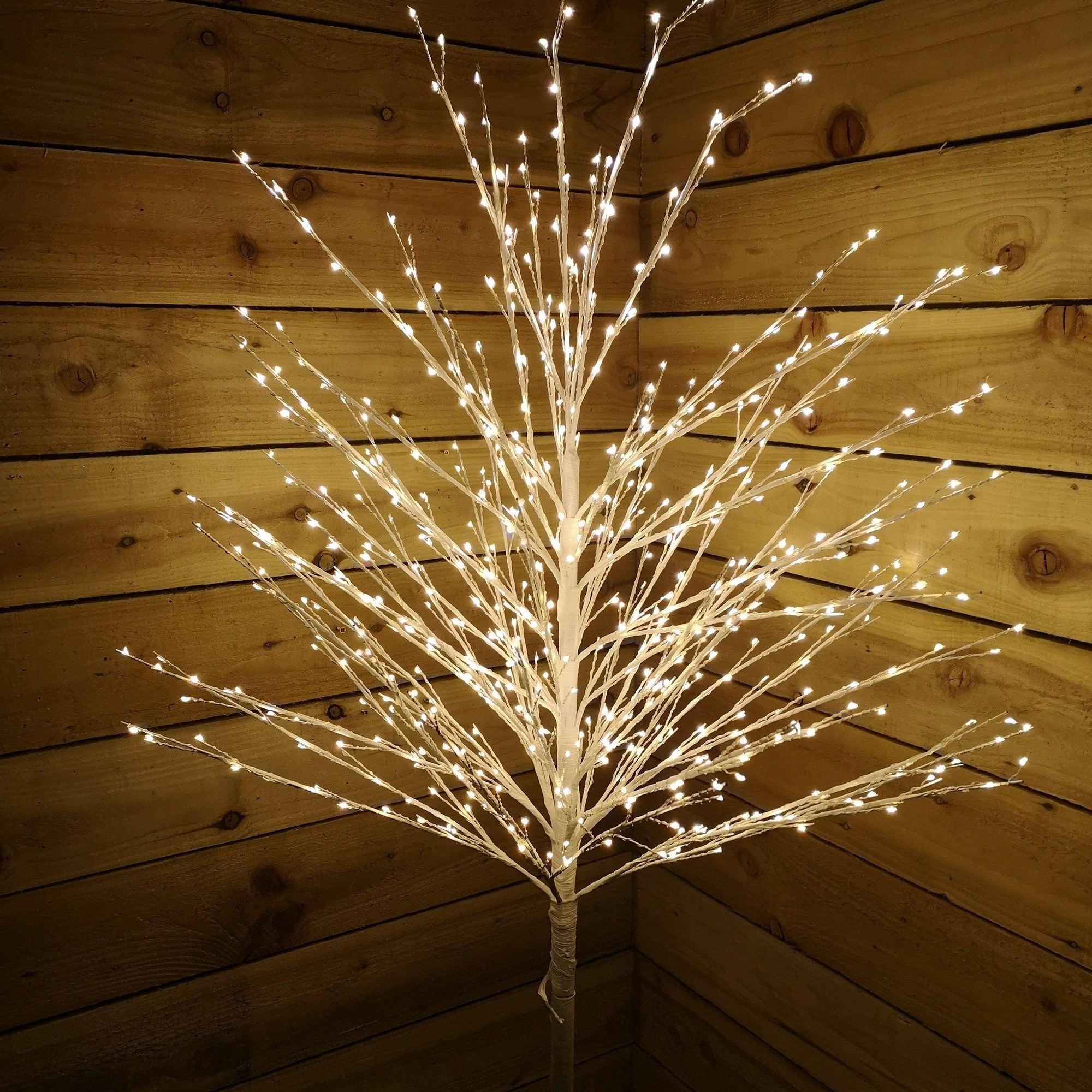 White micro dot tree with 900 warm white LEDs, standing 1.8M/6Ft tall, featuring a branch-like design and a sturdy base, set against a wooden backdrop.