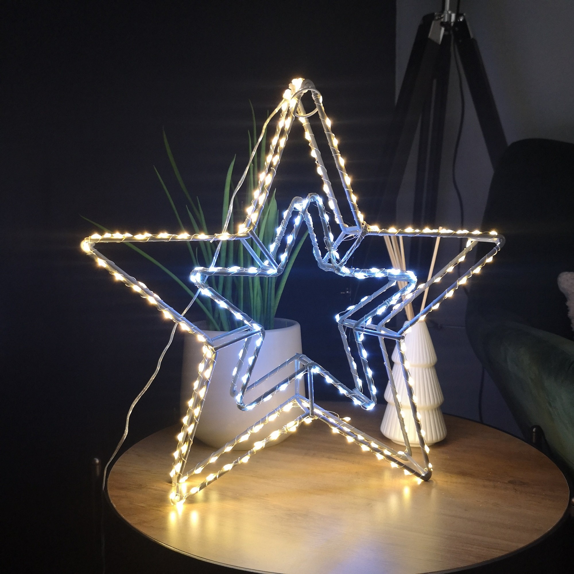 38cm LED dewdrop double star decoration featuring a grey metal frame with white and warm white lights, suitable for indoor and outdoor use, set on a wooden table.