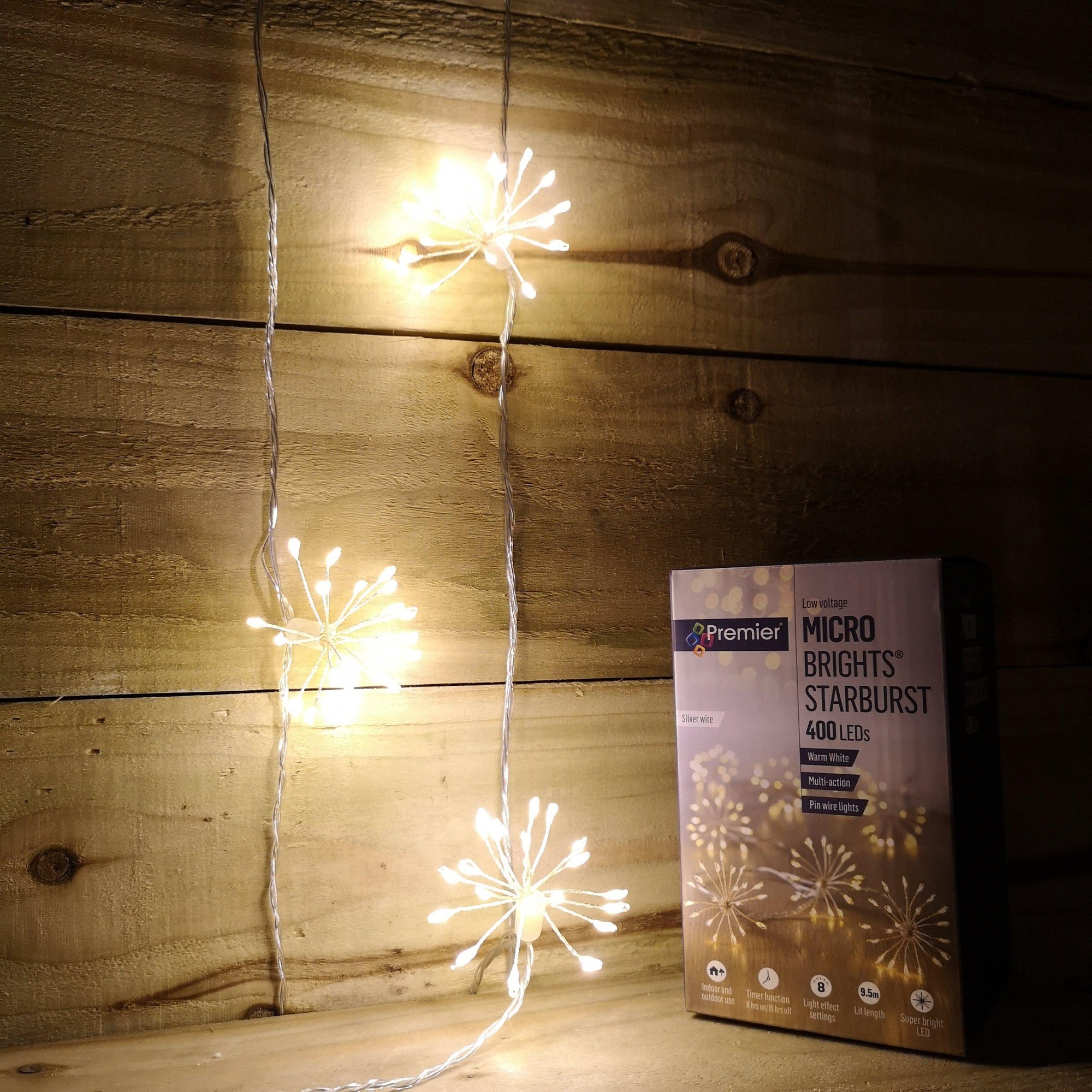 Warm white LED starburst lights with a flexible wire, featuring six starburst designs, next to a box labeled "Samuel Alexander Micro Brights Starburst 400 LEDs and Timer."